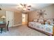 Well-lit bedroom with a ceiling fan, adjacent to a desk and view to another room at 2010 Bennett Rd, Grayson, GA 30017