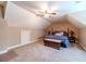 Spacious bedroom with dormered ceilings, a ceiling fan, and neutral carpet at 2010 Bennett Rd, Grayson, GA 30017