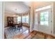 Charming dining room with hardwood floors, a chandelier, and a view of the front yard through glass doors at 2010 Bennett Rd, Grayson, GA 30017