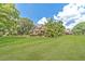Stunning house with sprawling front lawn, mature trees, and well-maintained landscaping at 2010 Bennett Rd, Grayson, GA 30017