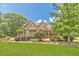 Charming stone home featuring a beautifully landscaped front yard with lush greenery and mature trees at 2010 Bennett Rd, Grayson, GA 30017
