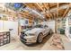 Spacious garage featuring a car, wall decorations, and ample lighting at 2010 Bennett Rd, Grayson, GA 30017