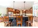 Kitchen with a large island, bar stool seating, stainless appliances, custom cabinets, and wood floors at 2010 Bennett Rd, Grayson, GA 30017
