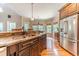Gourmet kitchen featuring granite countertops, stainless steel appliances, and hardwood floors at 2010 Bennett Rd, Grayson, GA 30017