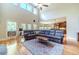 Spacious living room with vaulted ceilings, large windows, wood floors, and a comfortable sectional sofa at 2010 Bennett Rd, Grayson, GA 30017