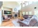 Spacious living room with a stone fireplace, hardwood floors, and a cozy seating area at 2010 Bennett Rd, Grayson, GA 30017