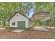 Exterior shot of outbuilding featuring a barn door and a covered space for parking at 2010 Bennett Rd, Grayson, GA 30017