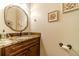 Elegant powder room with granite countertop and decorative mirror, perfect for guests at 2010 Bennett Rd, Grayson, GA 30017