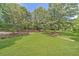 Expansive yard featuring green lawn and mature trees, offering privacy and space at 2010 Bennett Rd, Grayson, GA 30017