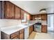 Functional kitchen featuring stainless steel appliances and wood cabinets, bathed in natural light from a window at 2116 Twin Falls Rd, Decatur, GA 30032