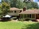 Expansive backyard featuring a mix of lawn and mature trees, creating a private oasis at 3746 Gladney Dr, Atlanta, GA 30341