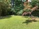 Secluded backyard with a lush lawn and shade trees, providing a tranquil and private retreat at 3746 Gladney Dr, Atlanta, GA 30341