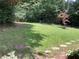 Grassy backyard with scattered trees and a birdbath, offering a peaceful outdoor setting at 3746 Gladney Dr, Atlanta, GA 30341