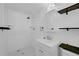 Clean bathroom featuring tiled shower, modern sink, and practical storage shelves at 3746 Gladney Dr, Atlanta, GA 30341