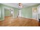 Bedroom with hardwood floors, ceiling fan, ensuite bathroom, and closet with mirrored doors at 3746 Gladney Dr, Atlanta, GA 30341