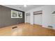 A minimalist bedroom with hardwood floors, good light, and open closet space at 3746 Gladney Dr, Atlanta, GA 30341