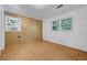 Bedroom featuring hardwood floors, light walls, and sunny windows with a window air conditioner at 3746 Gladney Dr, Atlanta, GA 30341
