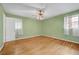 Bedroom features hardwood floors, ceiling fan, and two windows at 3746 Gladney Dr, Atlanta, GA 30341