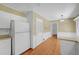 Eat-in kitchen features white cabinets, stainless fridge, and wood flooring at 3746 Gladney Dr, Atlanta, GA 30341