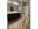 Well-lit bathroom featuring a double vanity and a glass-enclosed shower at 1604 Haven Cir, Douglasville, GA 30135