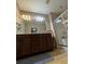 Well-lit bathroom featuring a double vanity and a glass-enclosed shower at 1604 Haven Cir, Douglasville, GA 30135