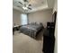 Comfortable bedroom featuring a tray ceiling, ceiling fan and neutral decor at 1604 Haven Cir, Douglasville, GA 30135