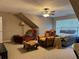Cozy bedroom featuring a ceiling fan, sitting area, and large window at 1604 Haven Cir, Douglasville, GA 30135