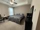 Comfortable bedroom featuring a tray ceiling, ceiling fan and neutral decor at 1604 Haven Cir, Douglasville, GA 30135