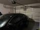 Garage interior with a black car, automatic door, and ample storage at 1604 Haven Cir, Douglasville, GA 30135