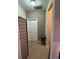 Hallway with carpet flooring, a side table, and a multi panel screen for privacy at 1604 Haven Cir, Douglasville, GA 30135