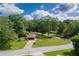 Aerial view of a charming single-story house with a long driveway and mature trees surrounding the property at 3888 Lindley Cir, Powder Springs, GA 30127