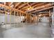Unfinished basement with studded walls and open ceiling rafters showcasing the potential for customization and additional space at 3888 Lindley Cir, Powder Springs, GA 30127