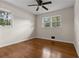 Bedroom features hardwood floors, neutral paint, ceiling fan, and windows for natural light at 3888 Lindley Cir, Powder Springs, GA 30127