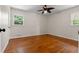 Bedroom featuring hardwood floors, neutral paint, ceiling fan, and windows for natural light at 3888 Lindley Cir, Powder Springs, GA 30127