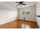 Bedroom features hardwood floors, neutral paint, ceiling fan, and windows for natural light at 3888 Lindley Cir, Powder Springs, GA 30127