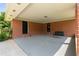 Spacious brick covered patio with outdoor seating and easy access to both a backyard and interior entrances at 3888 Lindley Cir, Powder Springs, GA 30127
