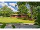 Charming brick home with well-maintained lawn and mature trees offering curb appeal at 3888 Lindley Cir, Powder Springs, GA 30127