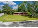 Inviting brick home with expansive front lawn surrounded by mature trees on a corner lot at 3888 Lindley Cir, Powder Springs, GA 30127