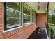 Classic brick front porch with black railings and large windows at 3888 Lindley Cir, Powder Springs, GA 30127