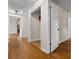 Hallway featuring hardwood floors, multiple doors, and an open doorway at 3888 Lindley Cir, Powder Springs, GA 30127