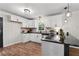 Bright kitchen with white cabinets, black countertops, stainless steel appliances, and modern lighting at 3888 Lindley Cir, Powder Springs, GA 30127