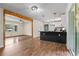 Open kitchen with wood floors, an island with bar, and views of the living room and backyard at 3888 Lindley Cir, Powder Springs, GA 30127