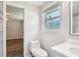 Bathroom featuring a toilet, single sink vanity, and shower with wire rack shelving and an open bedroom view at 6160 King Arthur Dr, Douglasville, GA 30135