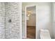 Bathroom boasts a tiled shower with a white tile surround and chrome fixtures plus wire rack shelves at 6160 King Arthur Dr, Douglasville, GA 30135