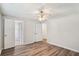 Well-lit bedroom with hardwood floors, a ceiling fan, and access to an ensuite bathroom at 6160 King Arthur Dr, Douglasville, GA 30135