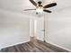 Bedroom features wood-look floors, a ceiling fan, and an open door to another room at 6160 King Arthur Dr, Douglasville, GA 30135