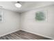 Bright bedroom with wood-look floors and a window with light-filtering blinds at 6160 King Arthur Dr, Douglasville, GA 30135