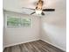 This bedroom boasts wood-look flooring, a window, and a modern ceiling fan at 6160 King Arthur Dr, Douglasville, GA 30135