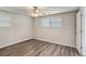 Comfortable bedroom with hardwood floors, windows providing natural light, and a ceiling fan at 6160 King Arthur Dr, Douglasville, GA 30135
