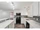 Modern kitchen featuring stainless steel appliances, white cabinets, gray backsplash, and marble-like countertops at 6160 King Arthur Dr, Douglasville, GA 30135